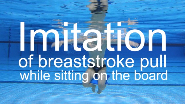 Imitation of a breaststroke pull while sitting on the board 